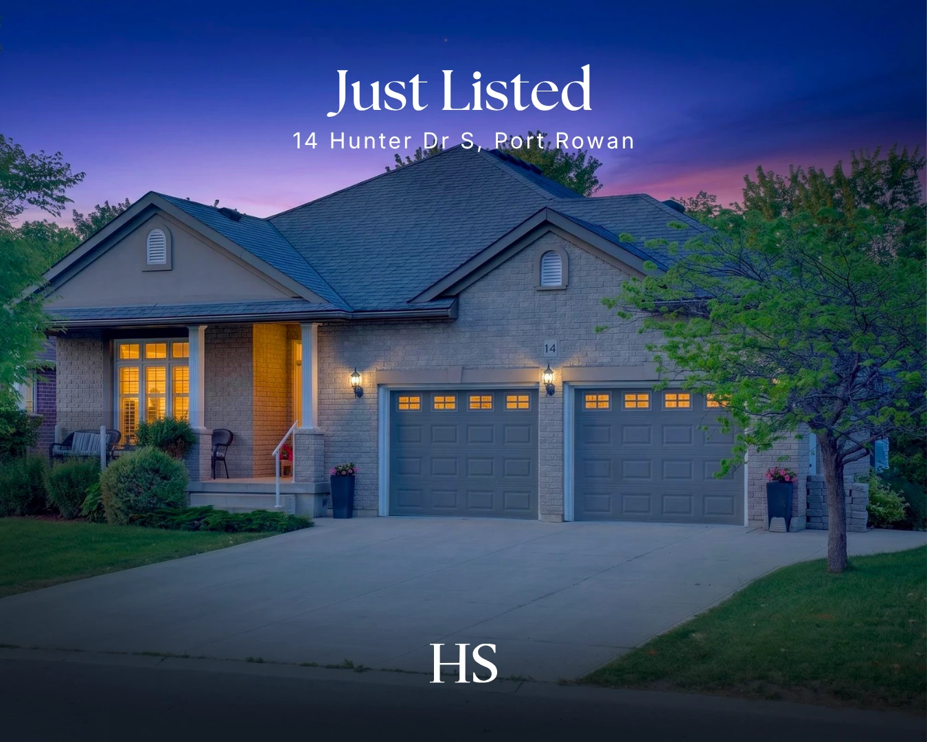 Dusk front elevation of a grey-stone bungalow with twin garages under a purple sky, captioned "Just Listed — 14 Hunter Dr S"