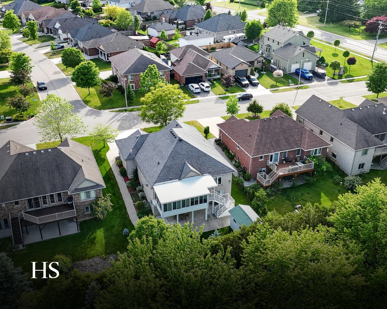 Drone aerial of the neighbourhood with the subject house centred in frame