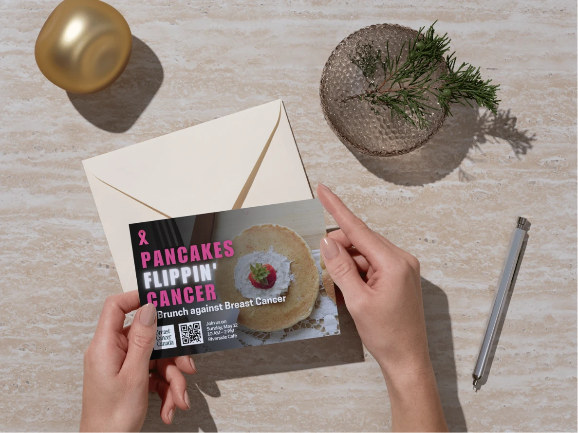 Invitation card mockup held over a styled table setting