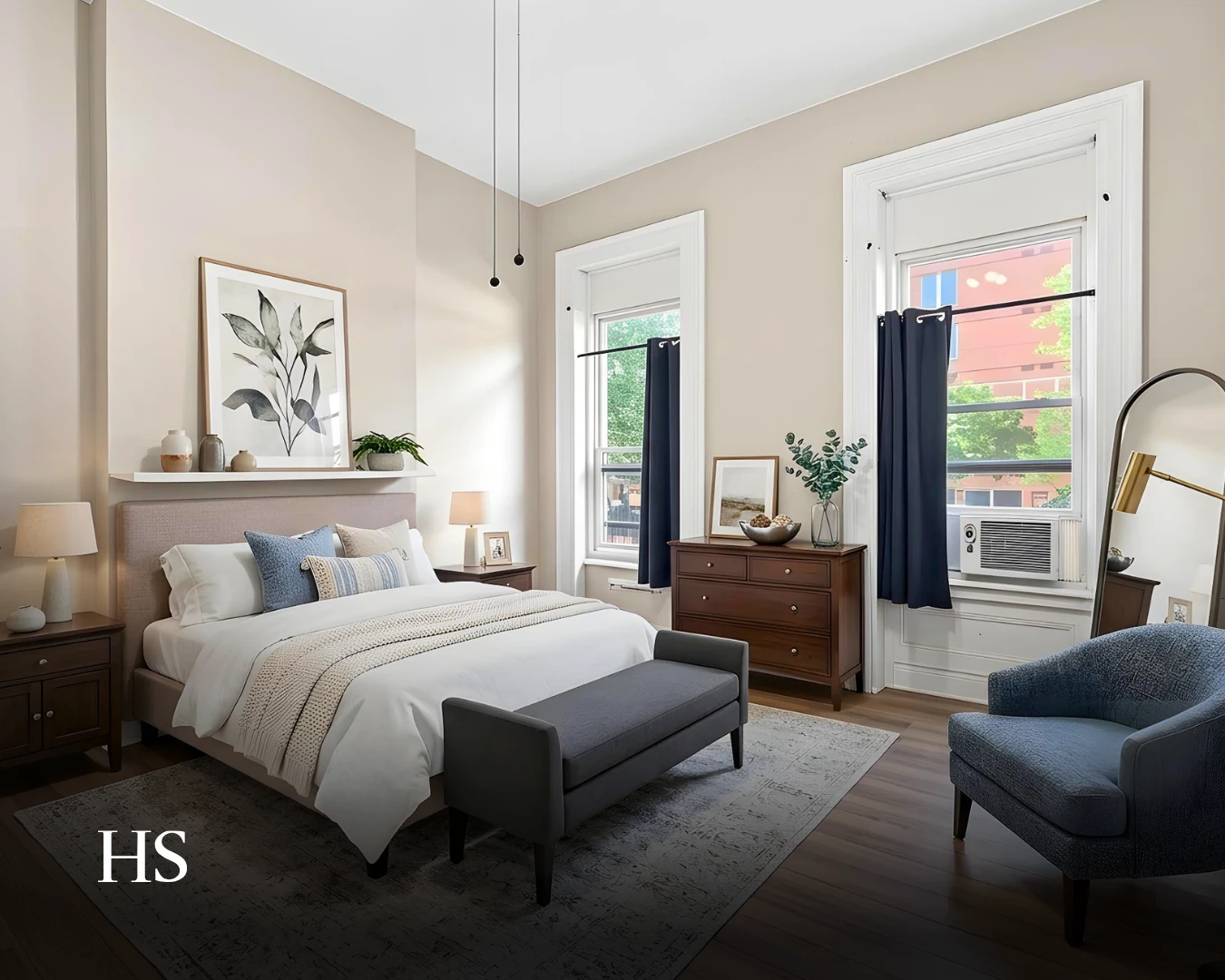 Bedroom with an upholstered bed and two windows dressed in dark curtains