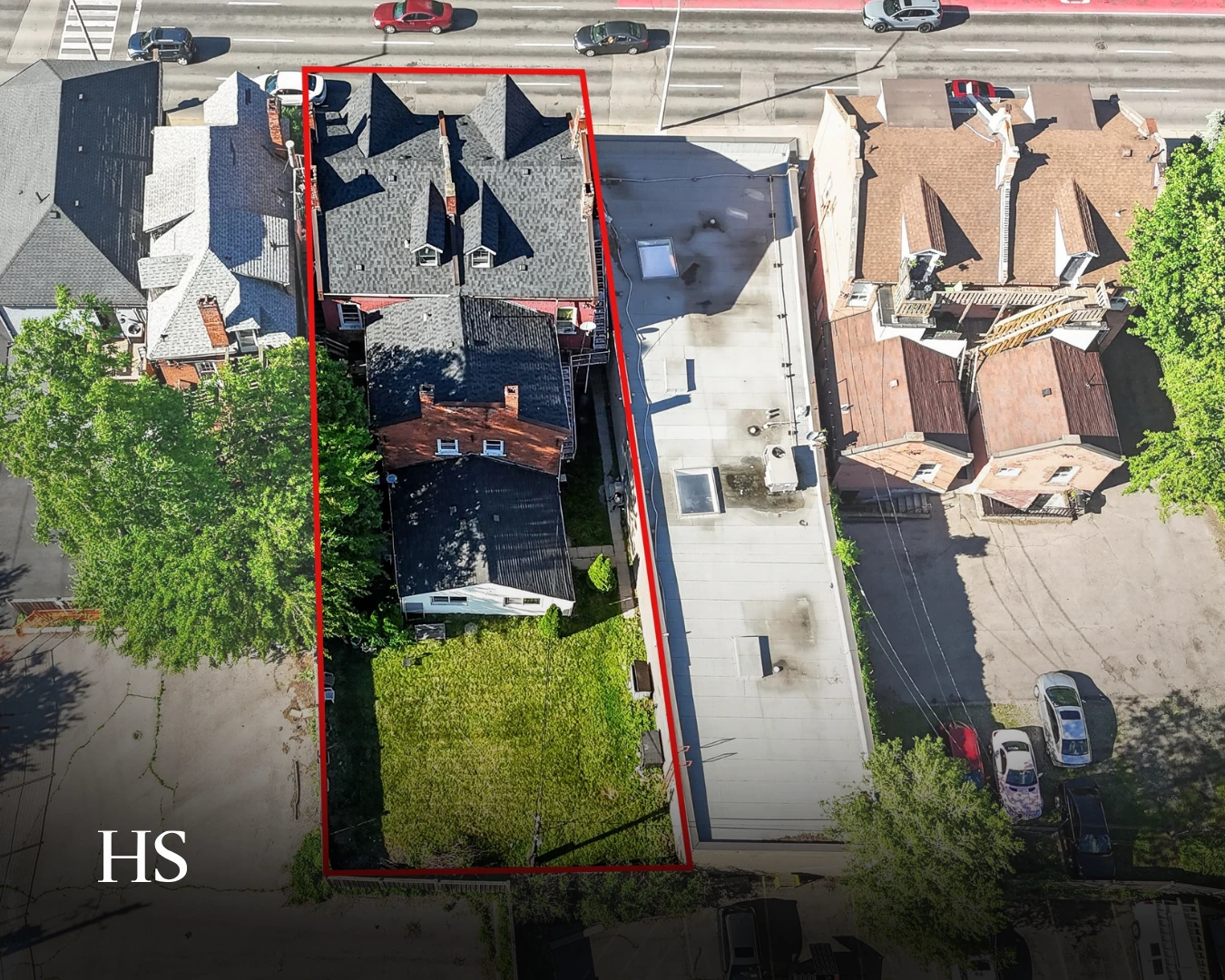 Aerial of the property outlined in red, with the adjacent lot and the street below