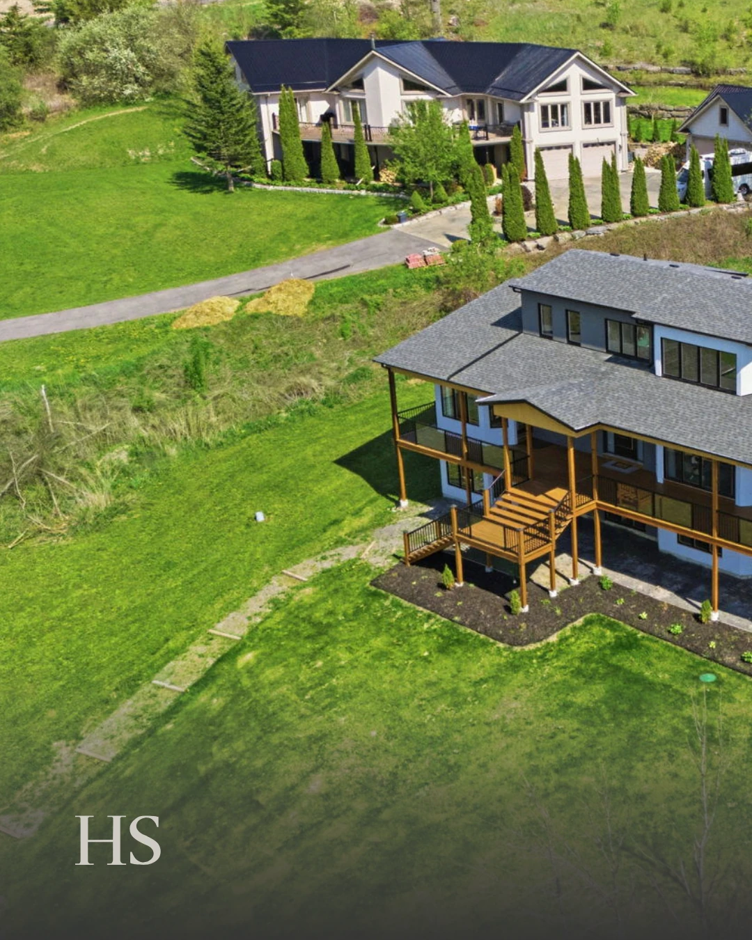 Drone aerial over the lot, showing the decks and a stepping-stone path
