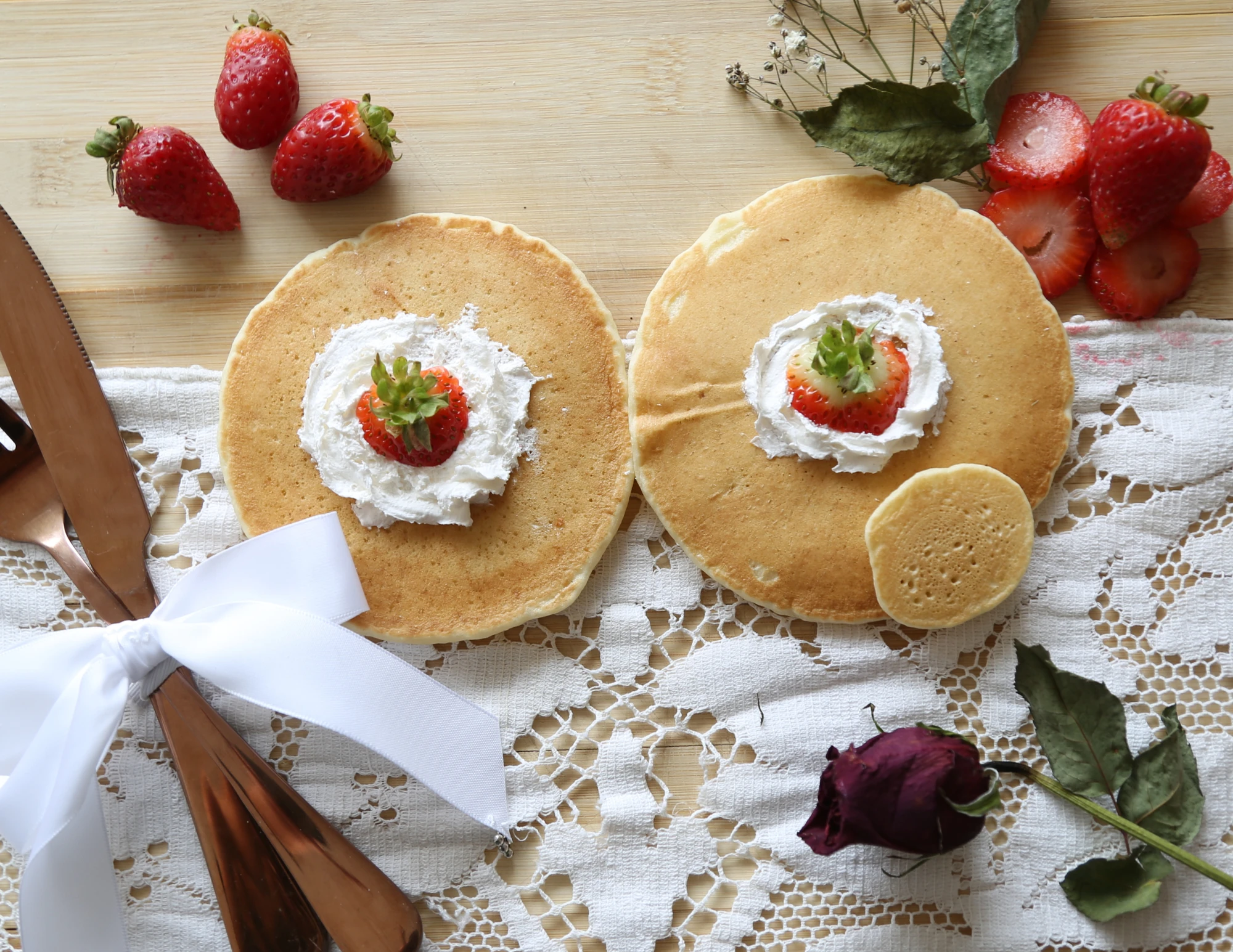 Raw pancake photograph with strawberries and cutlery